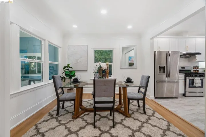 Bright dining area featuring wood-finish flooring, recessed lighting, and multiple windows