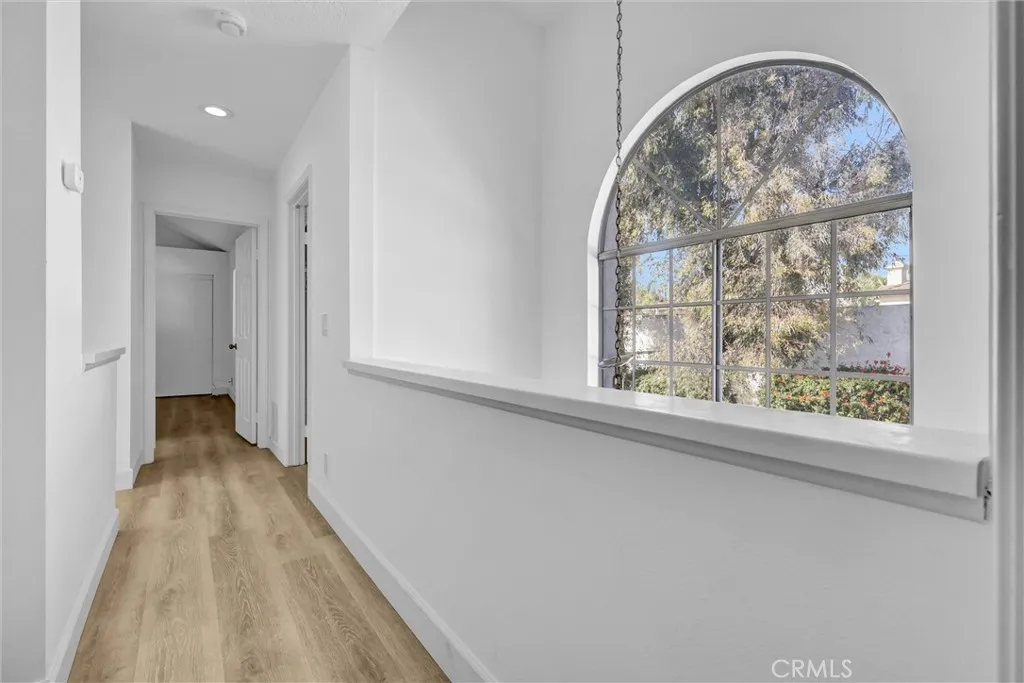 Hallway facing Main Bedroom at the end, Laundry room to the right and open vaulted area above the Front Entry
