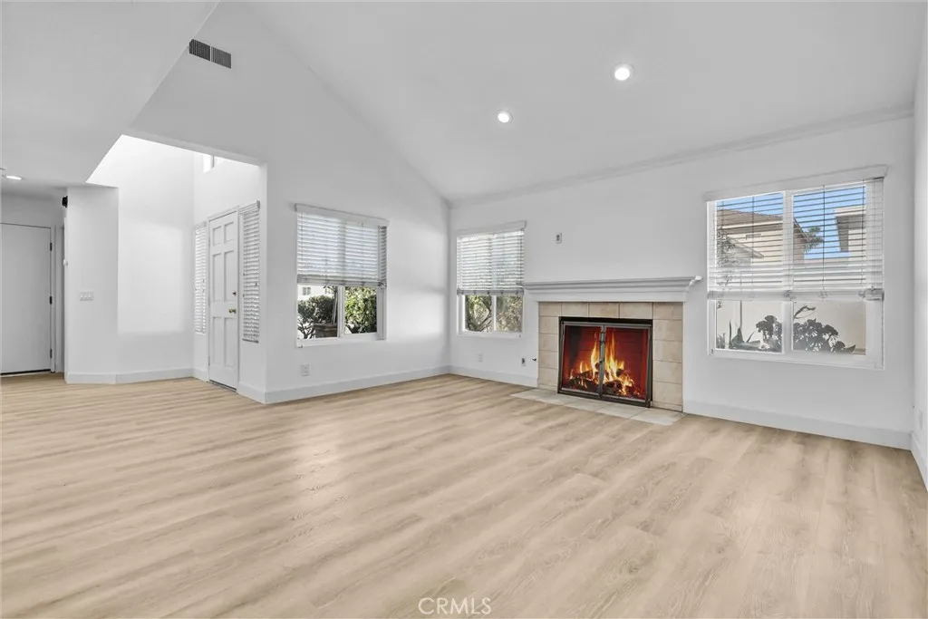 Full View of Living room with Fireplace and lots of natural light with Vaulted Ceilings