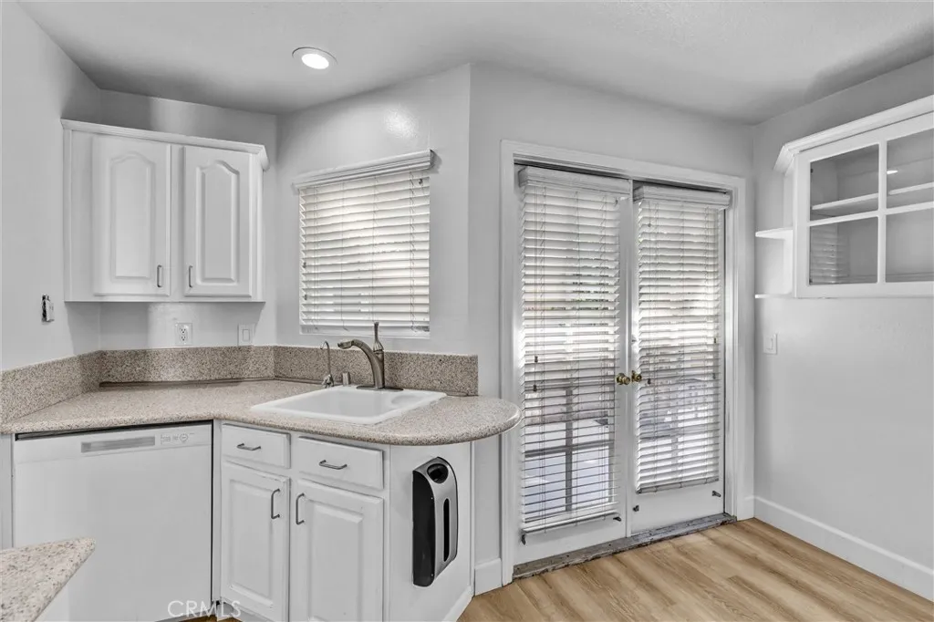 Kitchen Sink area, although blocked by window shades a "cute' box window above the sink area.