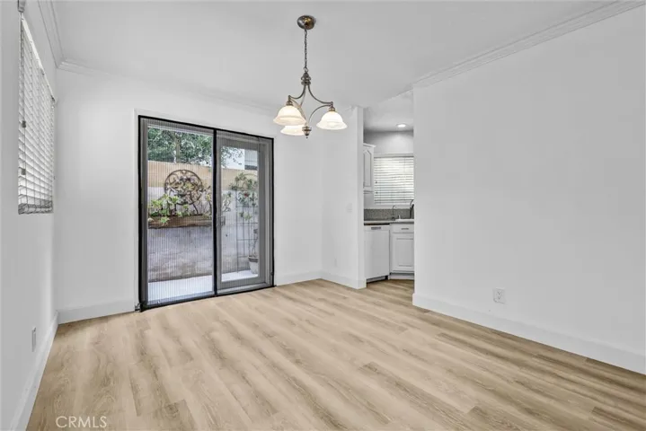 Dining Room with peek into the Kitchen and opening to the backyard