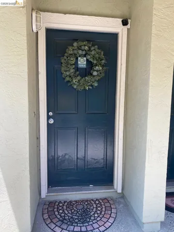 Entry door with a deep blue finish and decorative trim