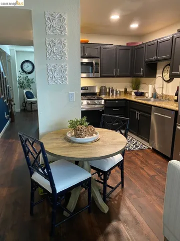 Efficient kitchen space featuring dark cabinetry, stainless steel appliances, granite countertops, and recessed lighting