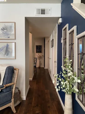 Hallway featuring wood-finish flooring