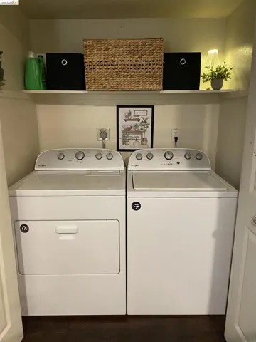 Dedicated laundry area featuring a white top-load washing machine and front-load dryer