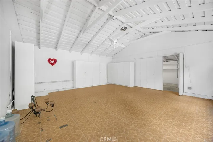 Rumpus Room with abundant storage & cabinetry and separate "Costco" storage room with racks- in its present condition