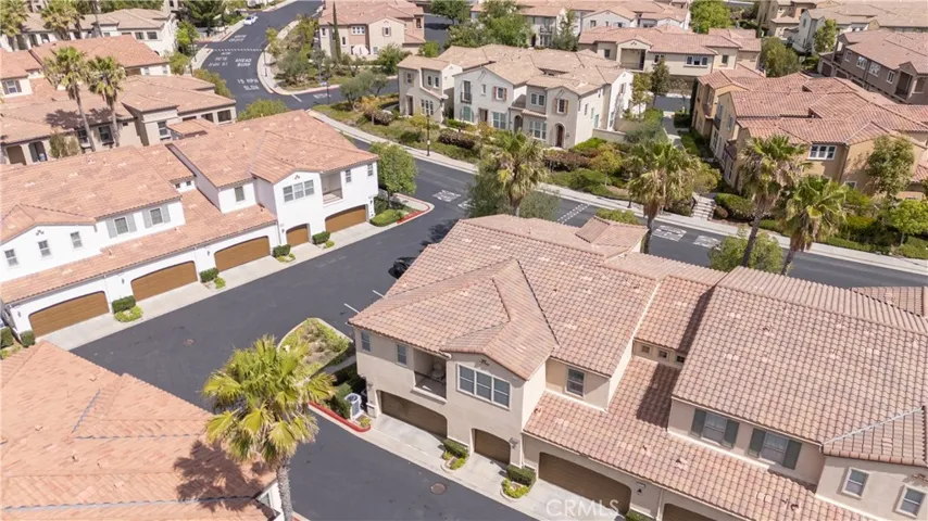 Aerial View of Well-Maintained Exterior with Garage Entry and Driveway