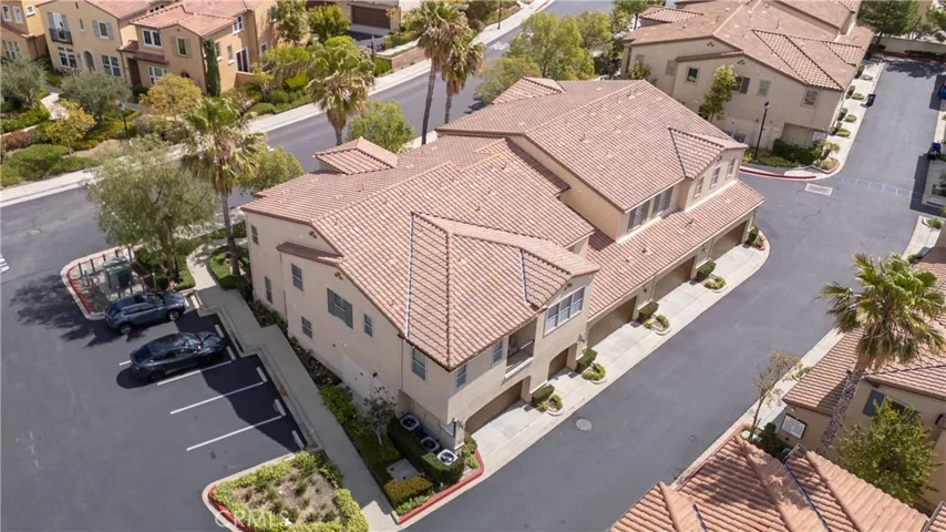 Aerial View of Well-Maintained Exterior with Garage Entry and Driveway