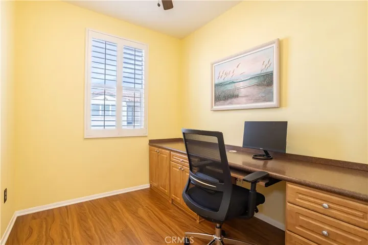 Versatile loft with plantation shutters and ceiling fan is ideal for a home office and separates the bedrooms