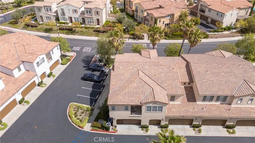 Aerial View of Well-Maintained Exterior with Garage Entry and Driveway