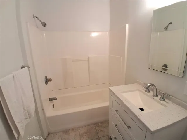 Enjoy a spacious primary bathroom designed with functionality and relaxation in mind.