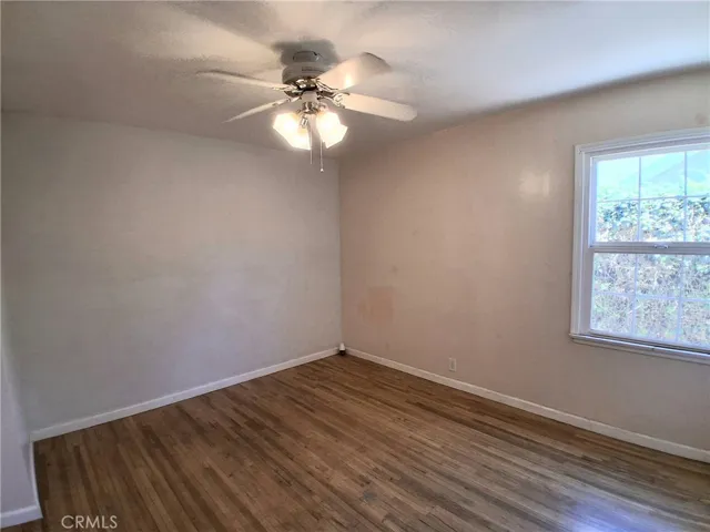 Bright and spacious second bedroom featuring a ceiling fan for added comfort.