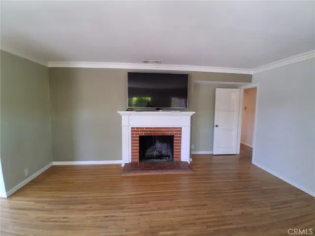 Timeless fireplace paired with stunning hardwood flooring for warmth and character.