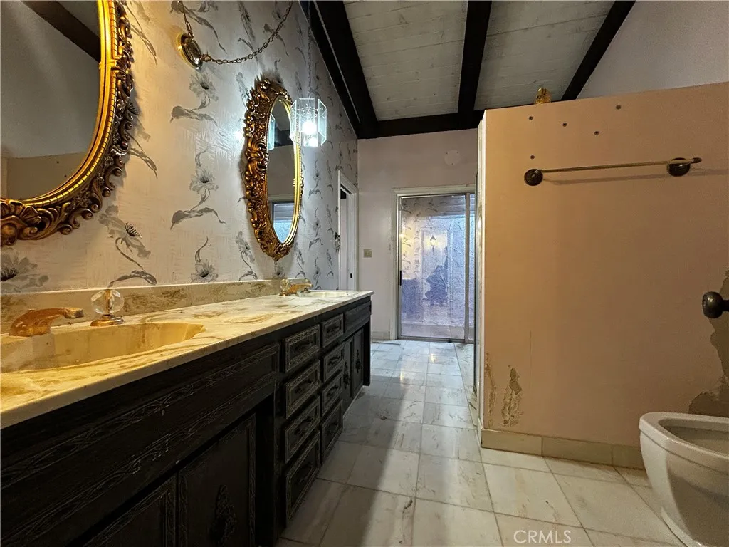 Full bath with sunken bathtub & extra room with skylight