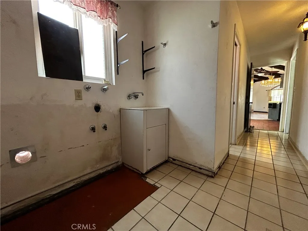 Laundry at end of hallway off kitchen