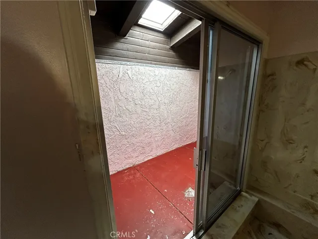 Full bath with sunken bathtub & extra room with skylight