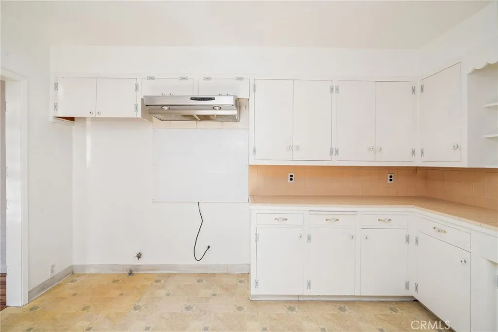 Room for refrigerator and neighboring stove (not included)