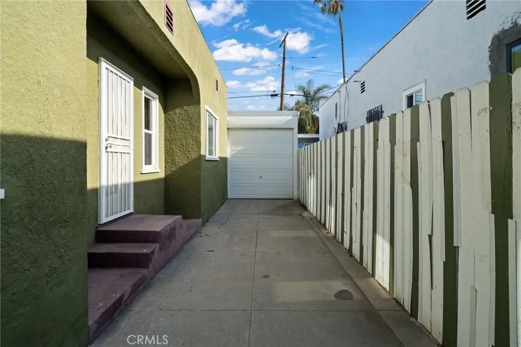 Long Driveway with side entry to house and Garage door that opens to a full 2 car garage in the back