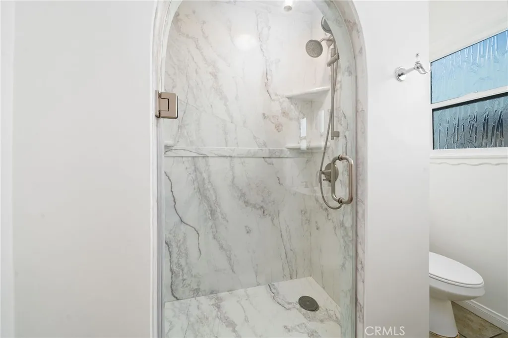 Beautiful marble Shower with arched glass door