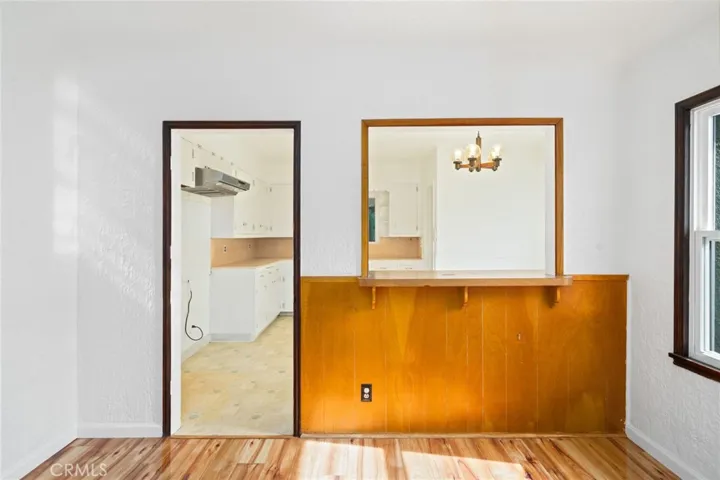 Pass Thru window into Kitchen keeping the dark trim from the era