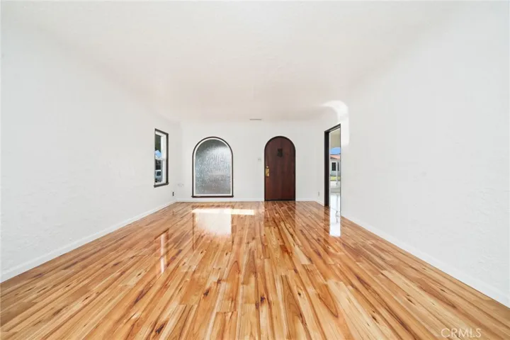 Living room with beautiful bamboo Opaque window with arch mathching front door