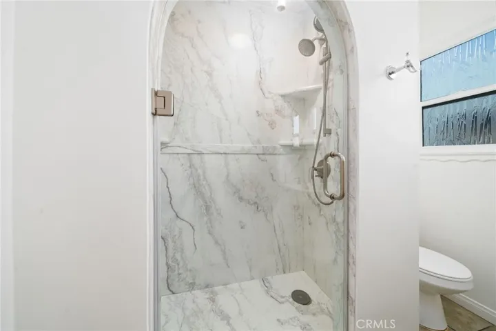 Beautiful marble Shower with arched glass door