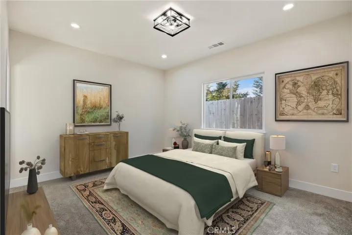 Primary Bedroom. Furniture virtual staged to show possible placement.