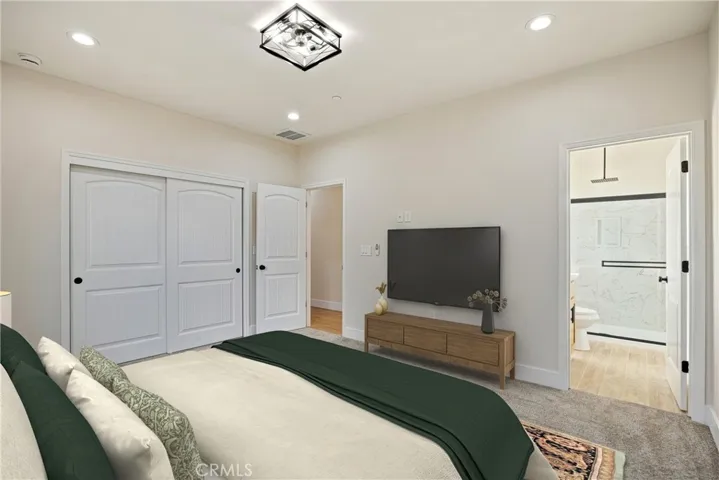 Primary Bedroom. Furniture virtual staged to show possible placement.