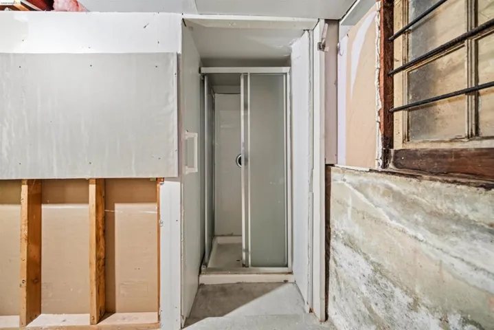 Compact shower enclosure with a white base and sliding frosted glass door
