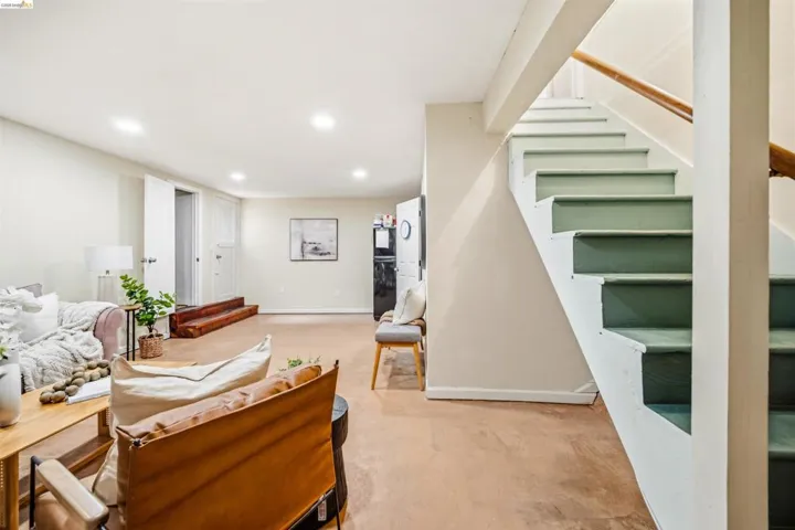 Spacious lower level featuring recessed lighting, light-toned walls, and durable flooring, with a staircase providing internal access