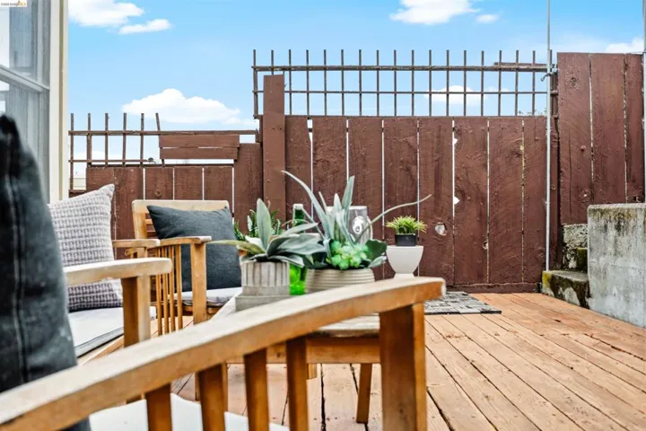 Wood decking featuring a privacy fence and concrete steps