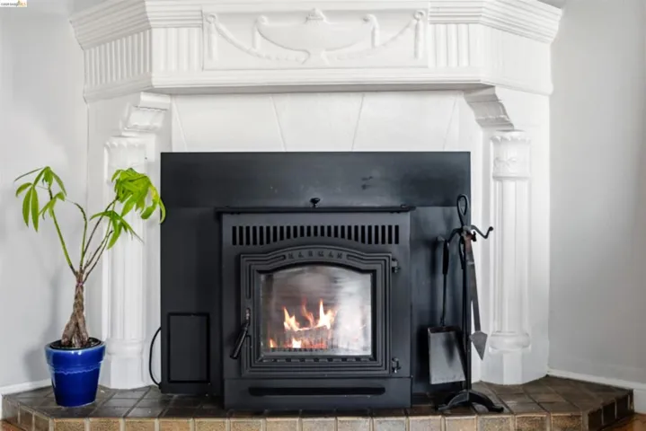 Corner fireplace featuring an ornate white mantel and hearth with ceramic tile