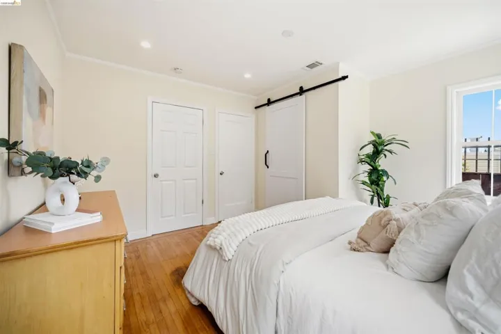 Bright interior space featuring wood-finish flooring, recessed lighting, and a white barn door