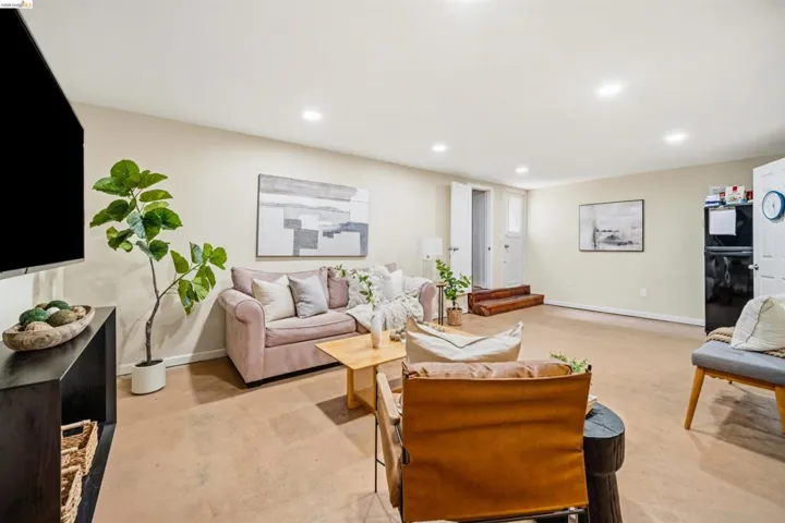 Spacious recreational room featuring recessed lighting, light-toned walls, and durable flooring
