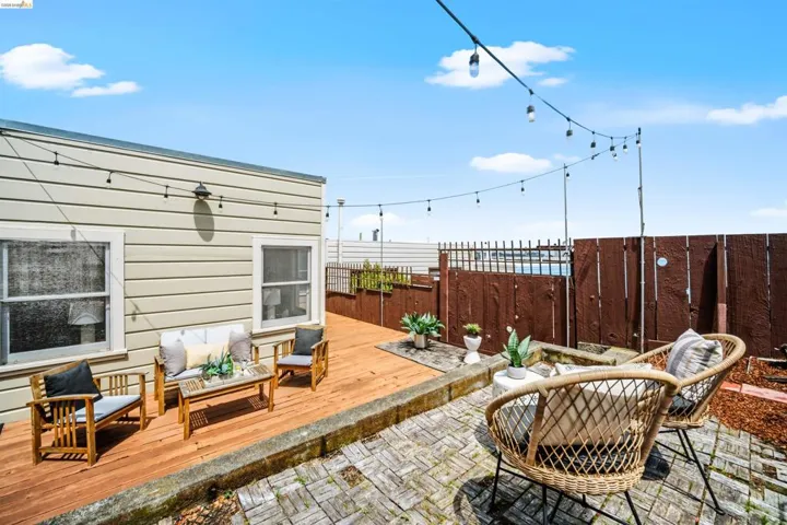 Outdoor patio featuring wood decking and brick paver flooring