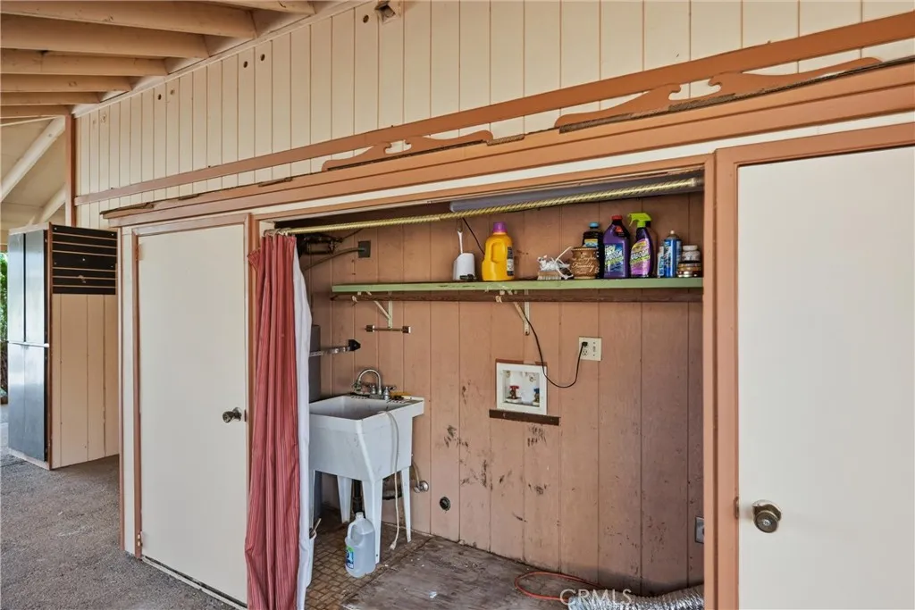 right outside kitchen is closet area covered for laundry