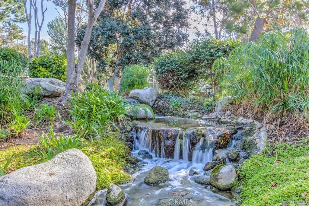 Community Landscaping – Garden-style common area with mature greenery stone accents, and the sounds or running streams.

