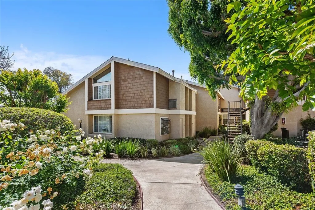 Exterior Front – Front exterior view showcasing mature landscaping and a welcoming residential setting.
