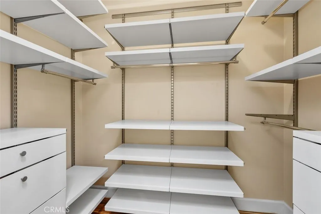 Closet – Spacious walk-in closet with built-in shelving and hanging storage.
