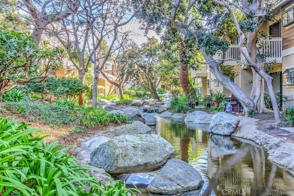 Community Grounds – Lush landscaped with lakes, streams, and mature trees and layered greenery.
