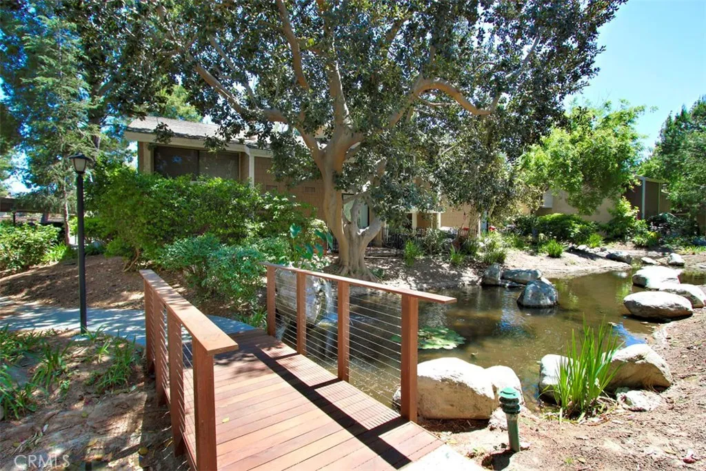 Community Grounds – Wood footbridges and lush landscaping create a peaceful outdoor community setting.
