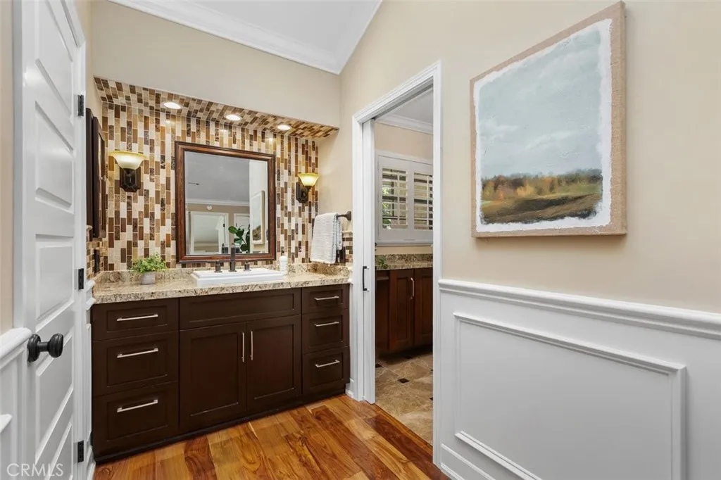 Bathroom – Updated bathroom featuring a framed mirror, tile surround, and a clean vanity area.
