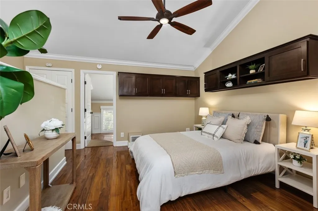 Bedroom – Bedroom with ceiling fan, hardwood flooring, and built-in cabinets for extra storage.
