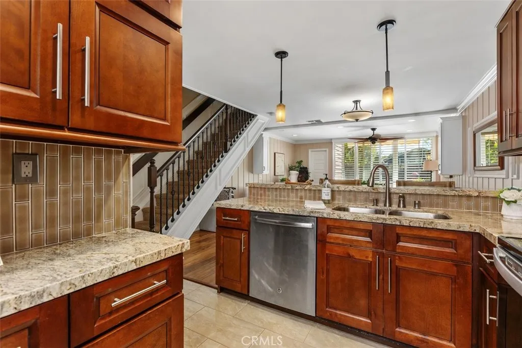 Kitchen – Fully updated with wood cabinetry, tile flooring, granite counters, and accent lighting.
