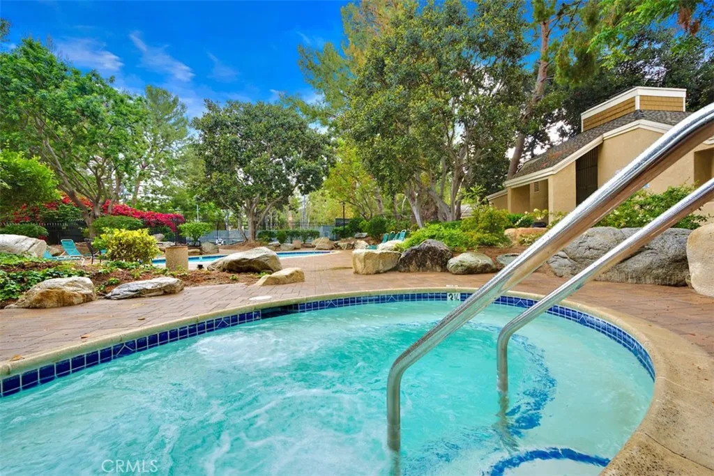 Community Pool – Bright pool view with surrounding greenery, lounge areas, and resort-inspired appeal.
