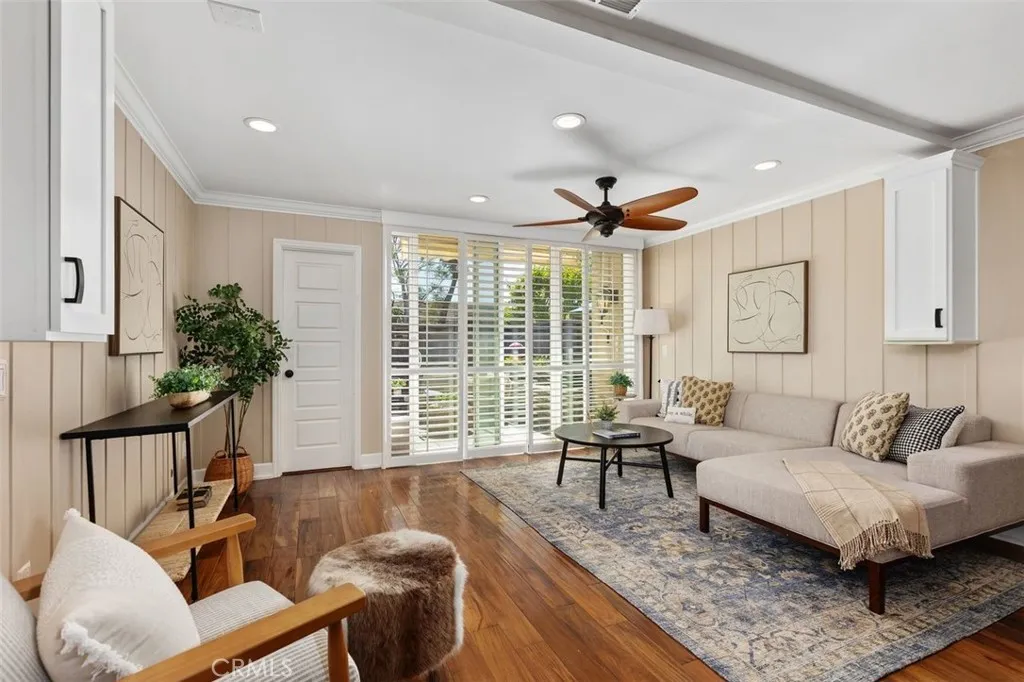 Living Room – Spacious living area, ceiling fan, and large windows that bring in natural light.
