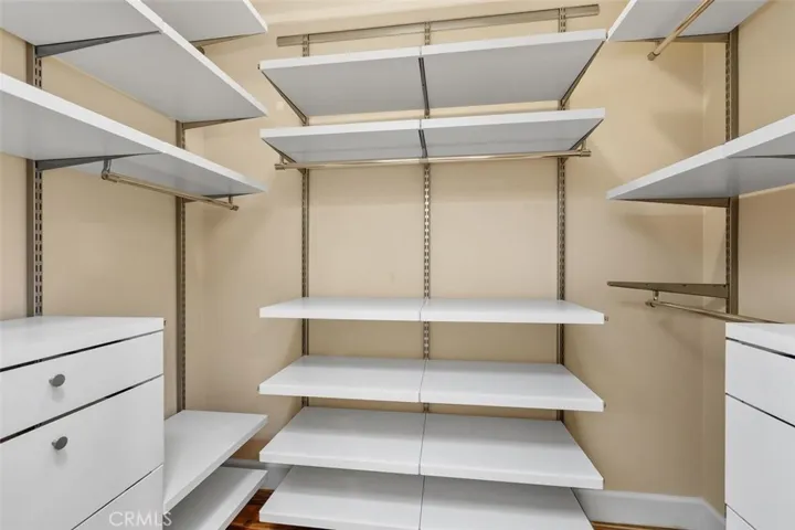 Closet – Spacious walk-in closet with built-in shelving and hanging storage.
