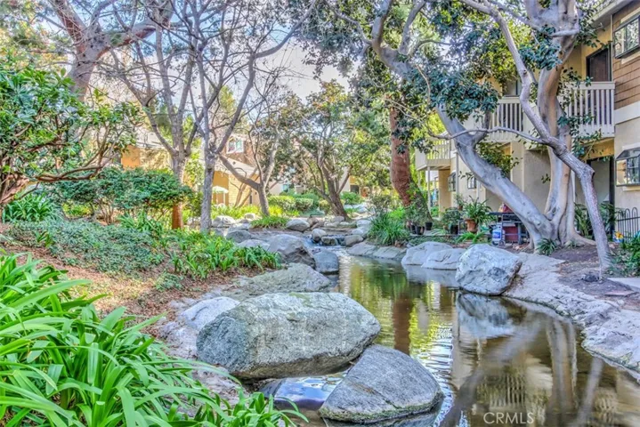 Community Grounds – Lush landscaped with lakes, streams, and mature trees and layered greenery.
