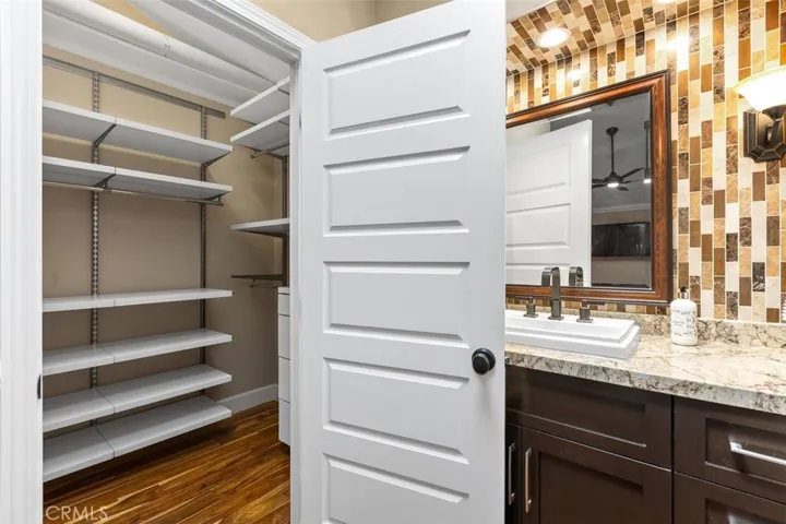 Walk-in Closet – With vaulted ceilings and a custom built-in closet organiser.