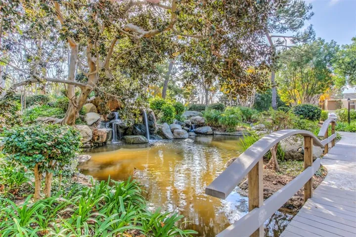 Community Grounds – Tree-lined community walkway with natural landscaping and shaded outdoor appeal.
